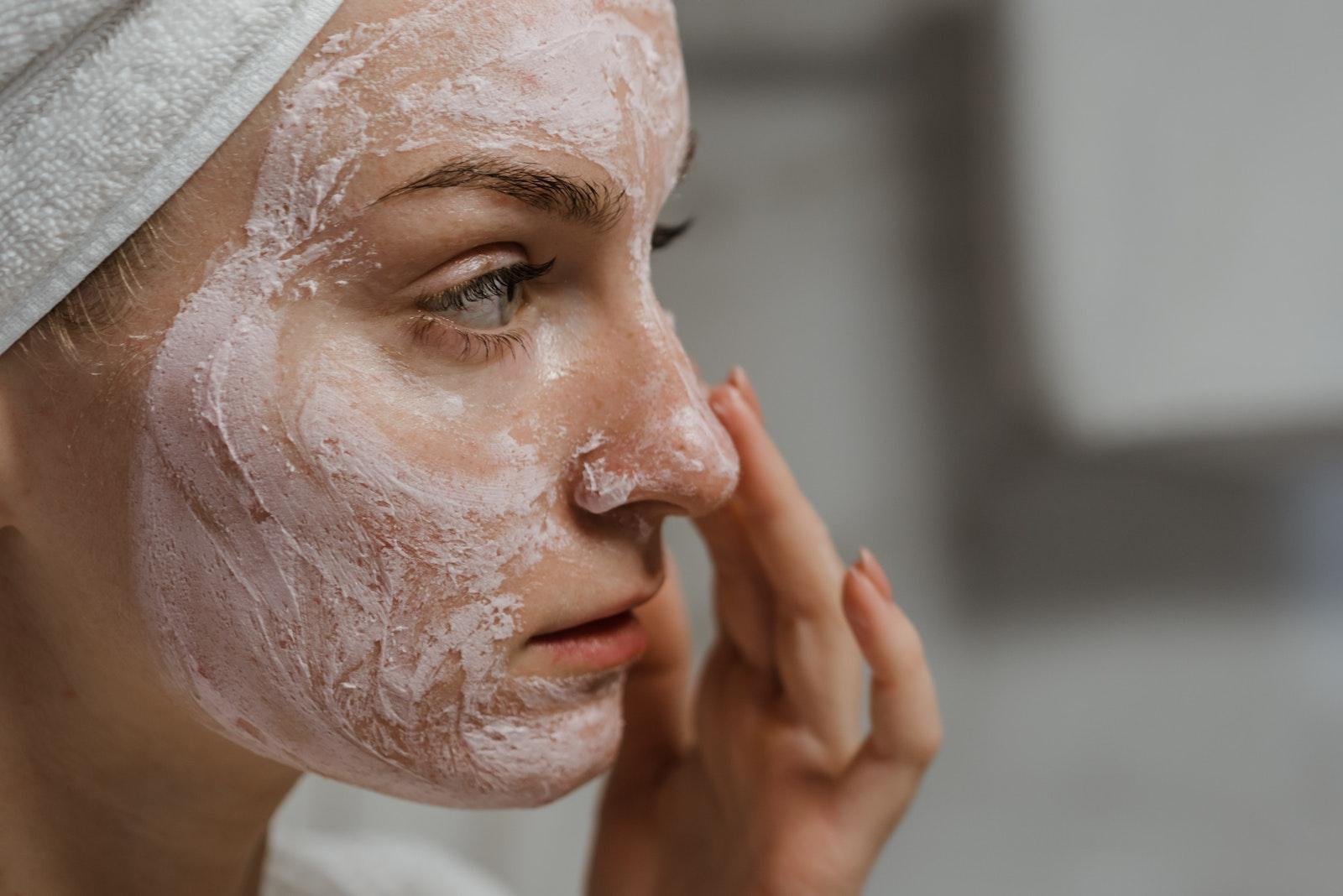 Close-up Photo of a Woman Applying Exfoliation