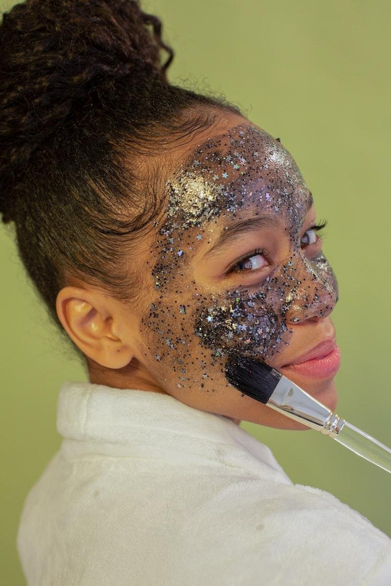 Young woman applying skincare for teens