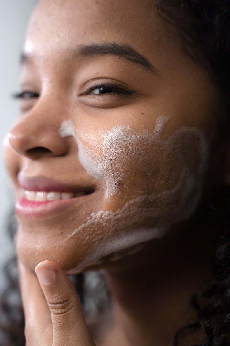 Woman Cleaning Her Face cleanser that contains surfactants