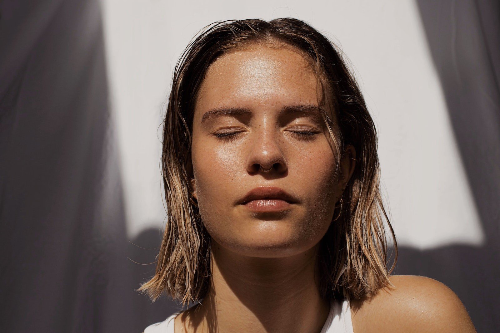 woman with dry skin in white tank top sunbathing 