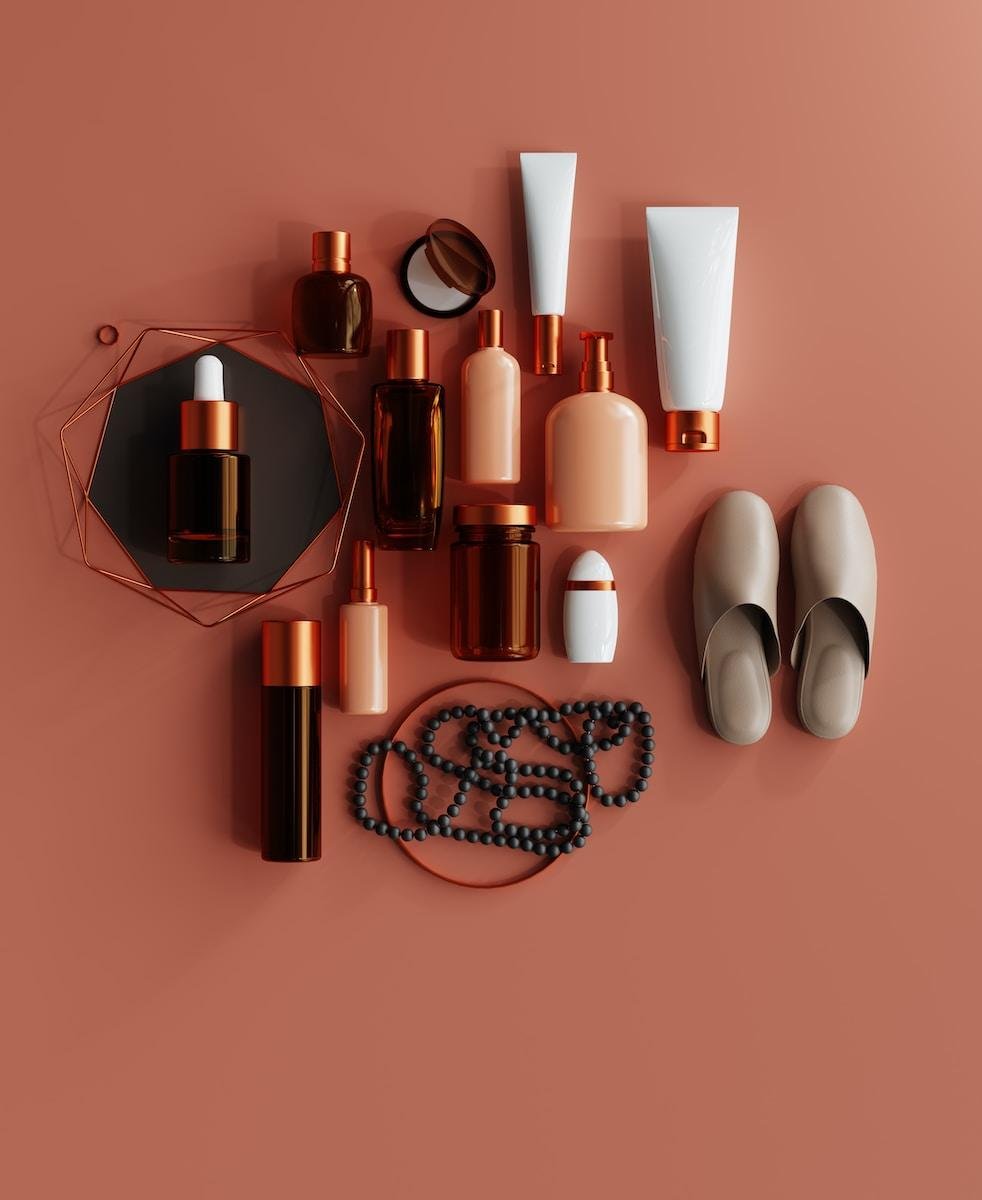 a collection skincare products on a pink surface